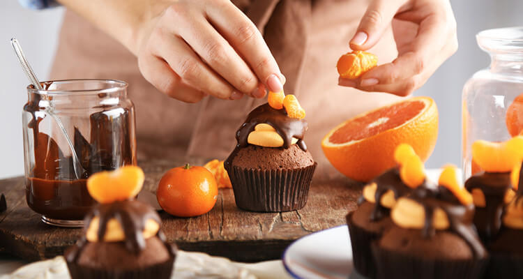 Chef decorating chocolate cupcakes
